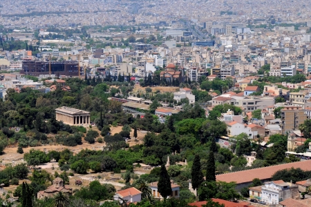 View of ancient temple of Hephaestus in Agora and city of Athens in Greeceの写真素材