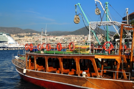 Recreational boat in the port against the background of the town of Kusadasi in Turkeyのeditorial素材