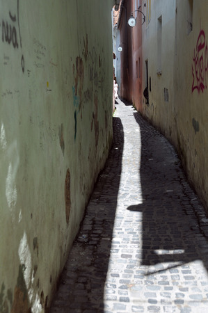 Strada Sforii is the narrowest street in the city of Brasov in Romaniaの写真素材