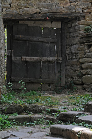 Verical image of the old wooden gate in monasteryの写真素材