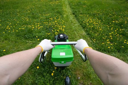 Mowing a grass. View from gardener eyesの写真素材