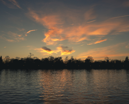 Sunset after the well-known pond located in the great park of El Retiro in Madridの写真素材