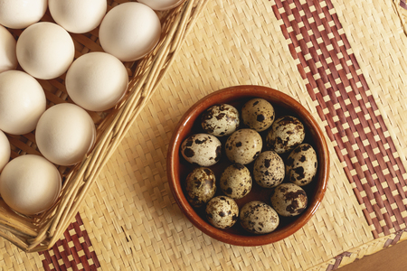 Freshly collected chicken and quail eggs, ready to make delicious recipesの写真素材