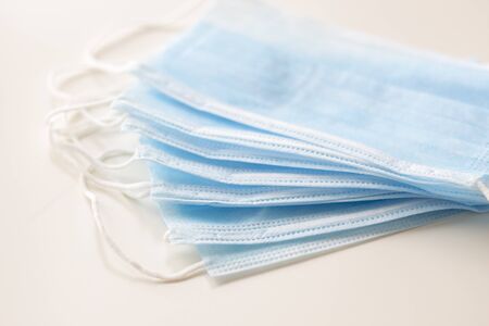 Blue medical masks, as protection against viruses, on white background, selective focus, concept, covid19の写真素材