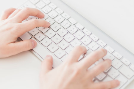Close up, Caucasian woman typing on a wireless keyboard. Business woman, selective focus, concepts