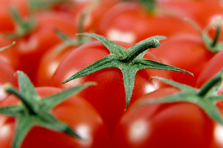 Several fresh ripe cherry tomatoes filling the whole frameの写真素材