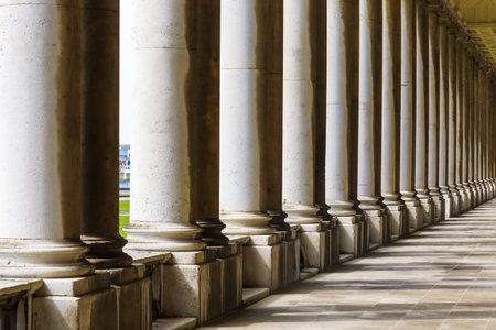 Colonnade and shadow in Old Royal Naval College, University of Greenwich, London.