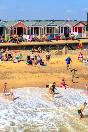 Southwold, UK - August 17, 2016 - Tourists sunbathing and playing on the Southwold beachのeditorial素材