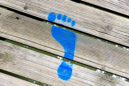 Blue painted footprint on Southwold Pier, UKの写真素材