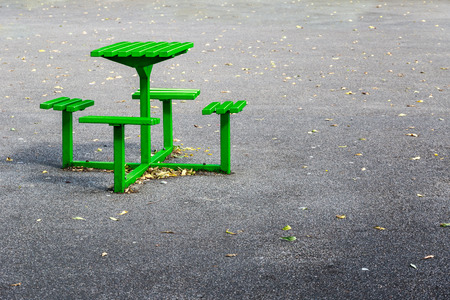 Green metal bench table set in a playgroundの写真素材