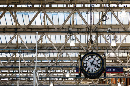 Hanging clock under the ceiling at Waterloo station in Londonのeditorial素材