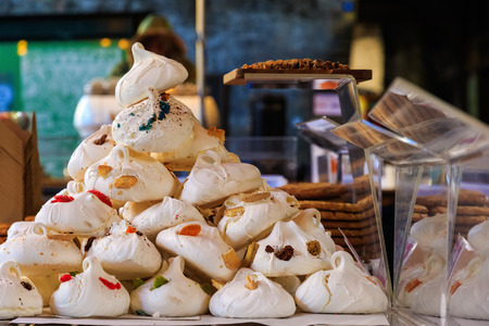 Meringues on display on a confectionery stall at Borough Market in Londonの写真素材