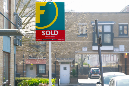 London, UK - March 27, 2017 - Estate agency sold sign outside a English townhouseのeditorial素材