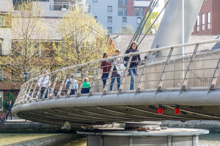 London, UK - May 10, 2017 - People crossing South Quay footbridge in Canary Wharfのeditorial素材