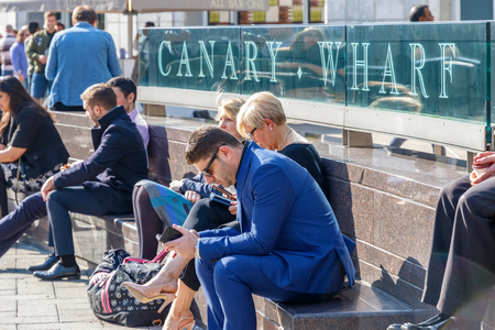 London, UK - May 10, 2017 - Outdoor space in Canary Wharf packed with people enjoying the sunny dayのeditorial素材