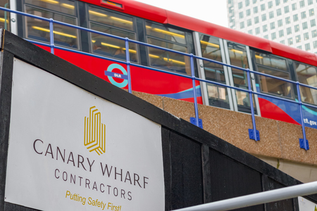 London, UK - May 24, 2017 - New development construction site in Canary Wharf with DLR train passing in the backgroundのeditorial素材