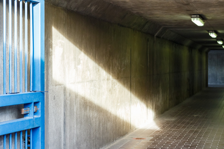 Thames Barrier passageway in London, sunlight cast into a dim and concrete corridorの写真素材