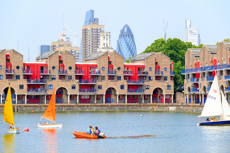 London, UK - June 21, 2017 - Shadwell Basin provides space for water sports and adventurous activities with dockside apartments and The Gherkin in the backgroundのeditorial素材