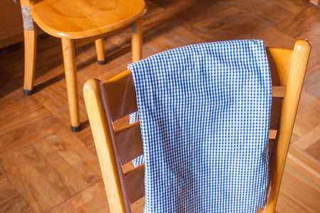 check shirt on the back of a chairの写真素材