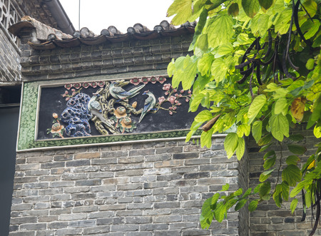 decorative painted sculpture on the top of the wallの写真素材