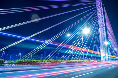 long exposure car light tracks with bridge backgroundの写真素材