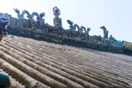 sculpture figures on the roof top of a houseの写真素材