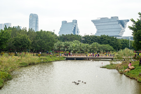 Guangzhou, China-Feb. 27, 2015: Modern buildings near the park.のeditorial素材