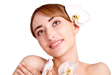 Beauty face of the young beautiful woman with flower の写真素材