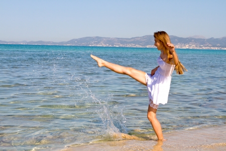 Happy young beautiful woman on the beach の写真素材
