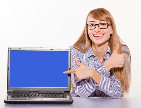 Smiling Businesswoman showing laptop with copy-space isolated on whiteの写真素材