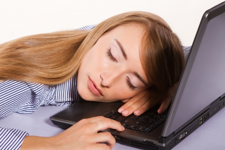 young businesswoman  sleeping on the laptop isolated on whiteの写真素材