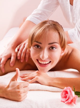 Beauty spa treatment  Smiling young women with thumb upの写真素材