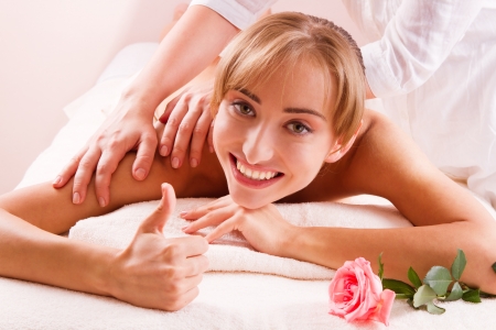 Massage Beauty spa treatment  Smiling young women with thumb upの写真素材
