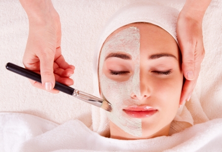 Woman receiving facial mask at beauty salon  macroの写真素材