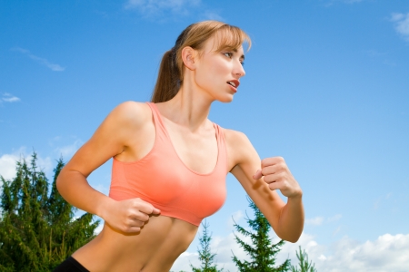 Pretty young woman runner in the forest.の写真素材