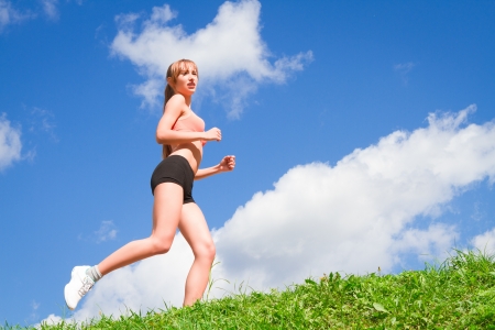 Pretty young woman runner in the forest.の写真素材