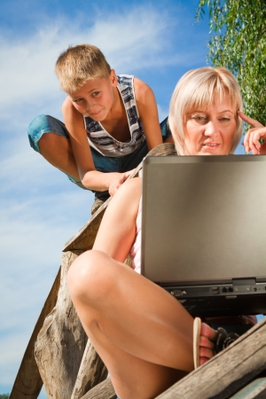 boy and woman with laptop outdoorsの写真素材