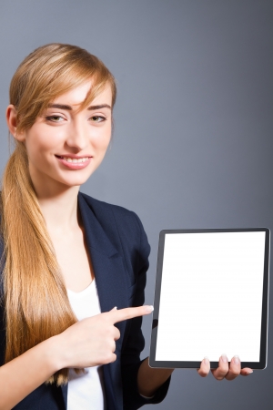 Young woman showing a tablet PC の写真素材