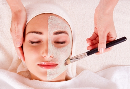 Woman receiving facial mask at beauty salon. macroの写真素材
