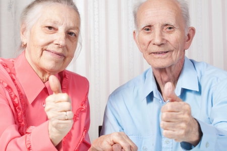 Closeup portrait positive elderly couple happy, thumbs-up gestureの写真素材