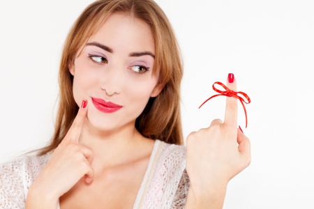 woman red bow on finger, isolated on white backgroundの写真素材