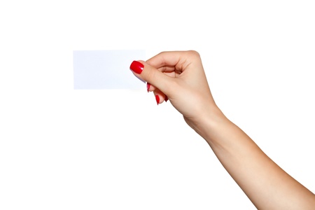 Hand with a business card and a red manicure close-up on a white background の写真素材
