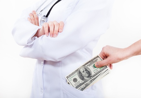 Patient bribing doctor, putting money to pocket の写真素材