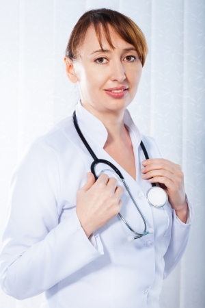 Beautiful female doctor with stethoscope の写真素材