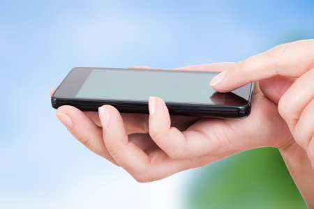 mobile smatphone in woman s handsの写真素材