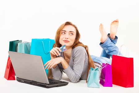 Beautiful young woman shopping over internetの写真素材