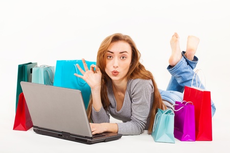 Beautiful young woman shopping over internetの写真素材