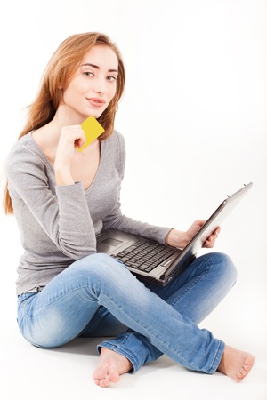 Beautiful young woman shopping over internet,の写真素材