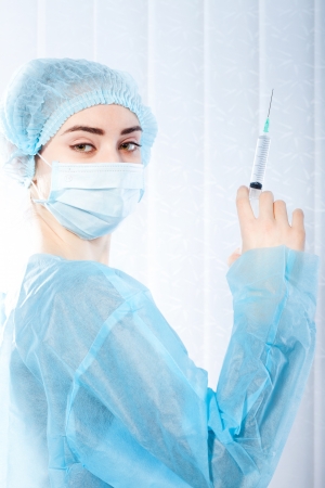 Portrait of  woman doctor, surgeon with syringeの写真素材