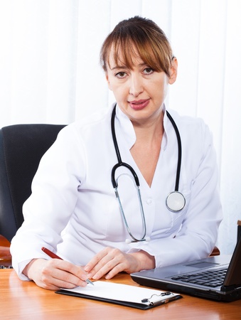 Female doctor showing blank clipboard の写真素材